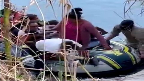 Video Shows Massive Group Of Migrants Being Guided Across Texas River