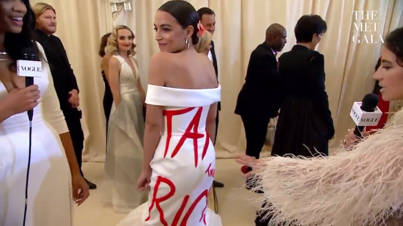 AOC wearing a designer dress with TAX THE RICH on it