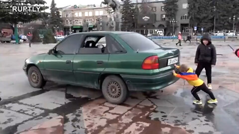 A two year old Armenian boy manages to push a car alone