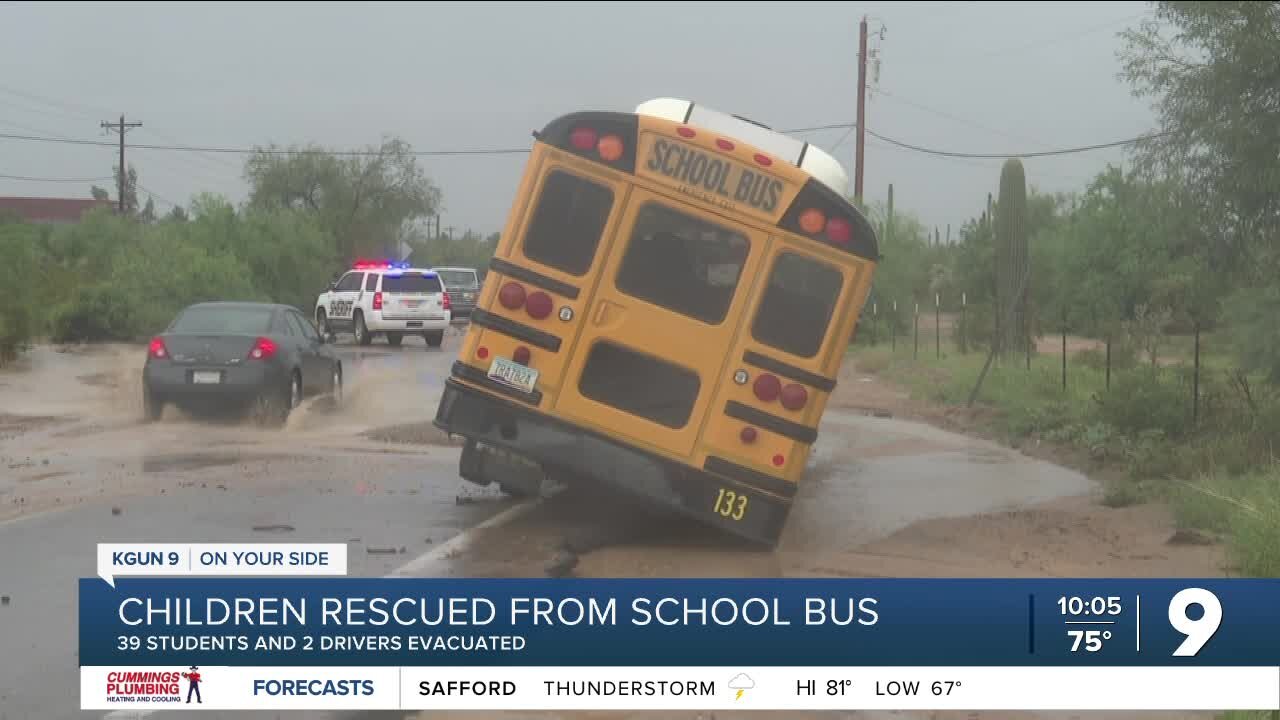 Children rescued from school bus in flood water