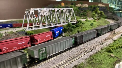 N Scale dirty EMDs pulling long coal drag