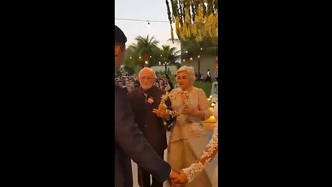 great-grandparents entering with rings at their grandson's wedding