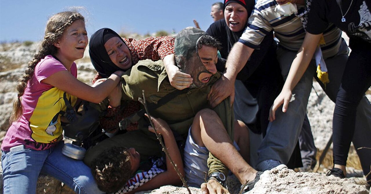 Palestinian women and children fight off Israeli soldier with boy in chokehold