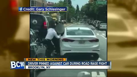 Driver pinned against car in road rage incident