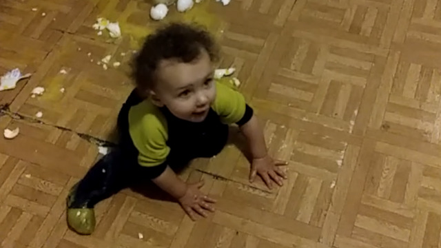A Girl Hilariously Struggles To Stand Up On The Kitchen Floor