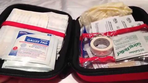 Unboxing and unpacking the red, travel Coleman Expedition 205 piece emergency First Aid Kit 7604