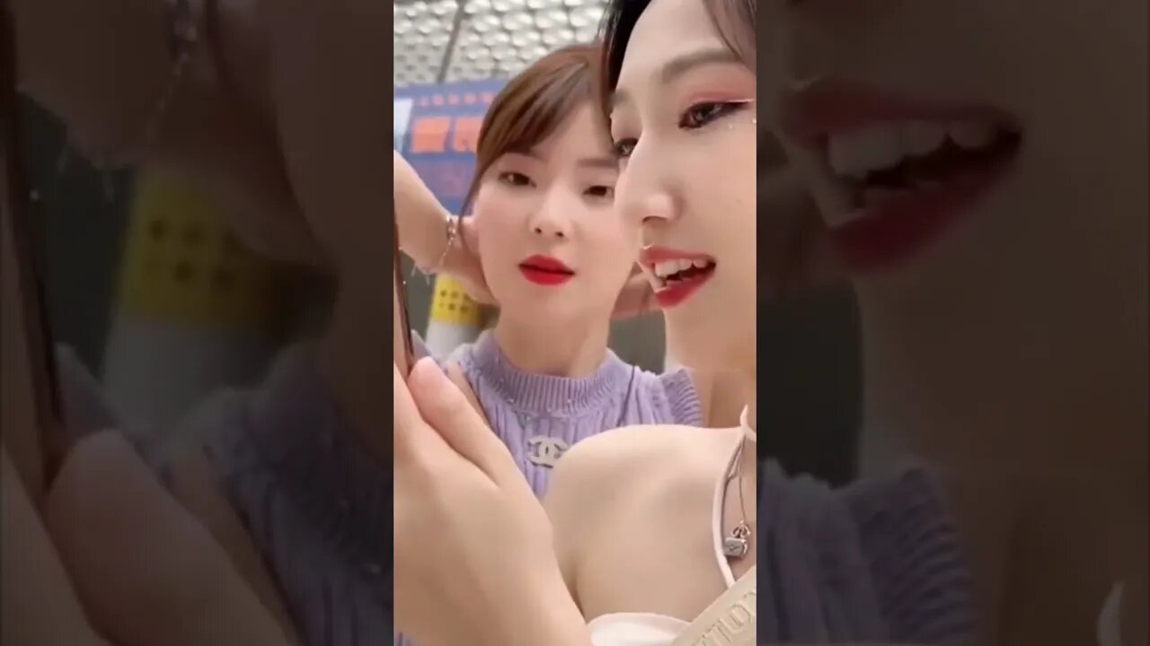 Two Hot Chinese Girls Checking Out Their Phone