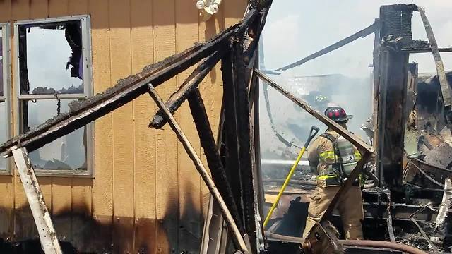 Rural Metro firefighters battle mobile home fire