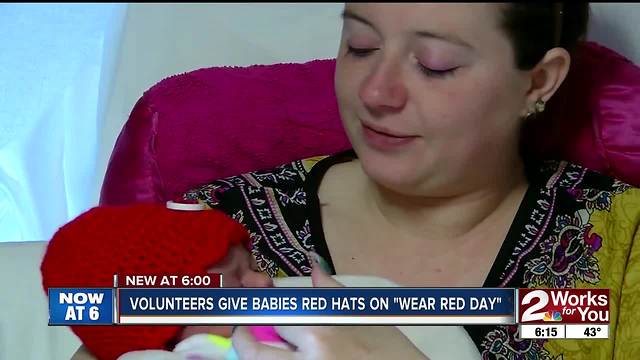 Volunteers donate red hats for heart disease awareness