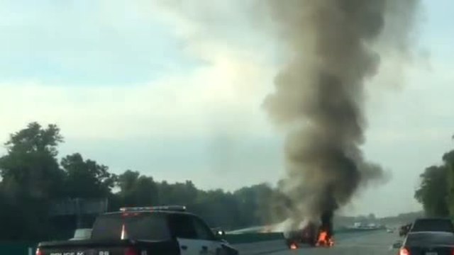 Truck catches fire after flipping over median wall on I-75