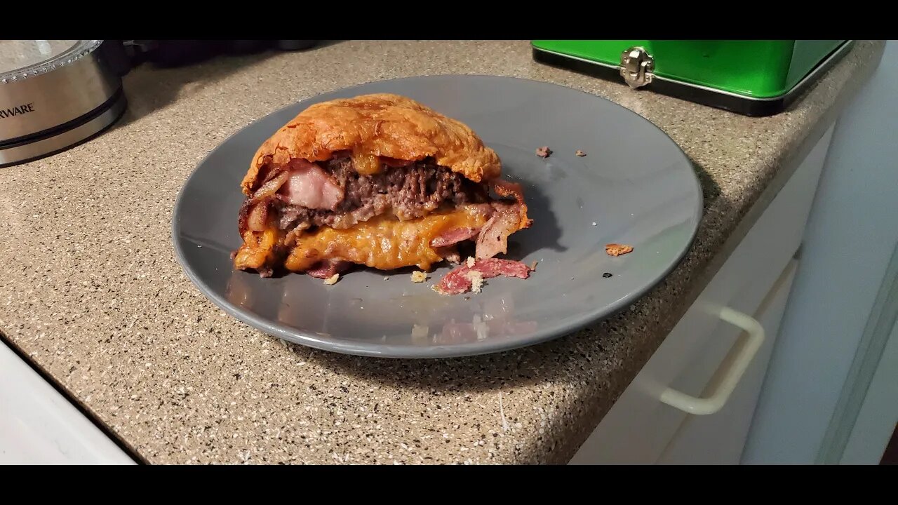 Attair Cooks a Hamburger Bacon Rollup