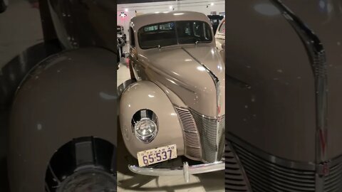 Row of 1940s Fords with woodie station wagon