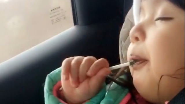 Adorable baby licks her lollipop to sleep