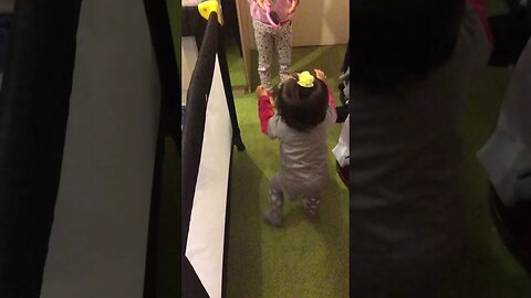 Little cutie walking her very first steps- her sister encouraging her