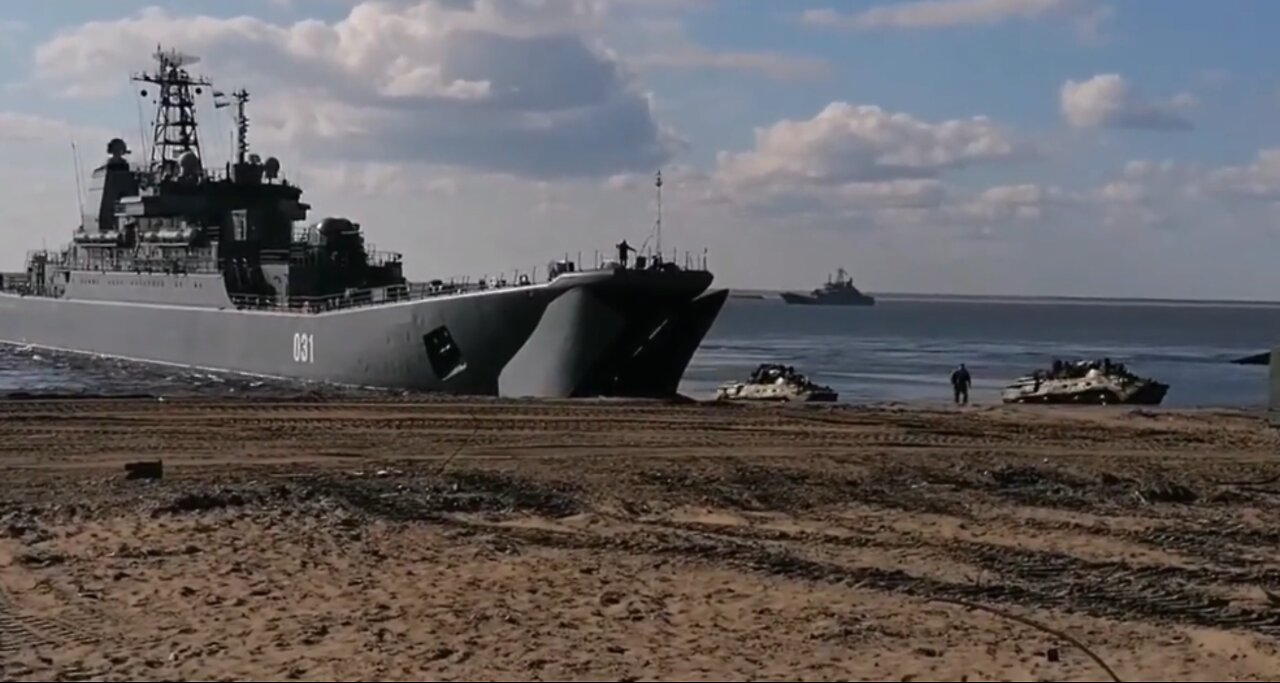 Landing of troops and military vehicles with Big Landing Ships on the beach.