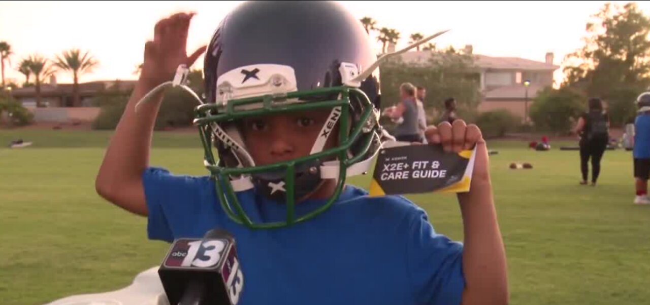 Raiders give away helmets at football camp