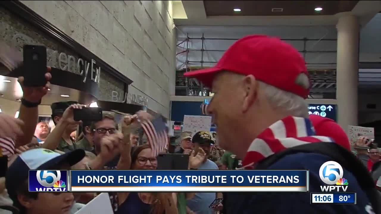 Thousands of people pack the PBIA concourse to welcome home Honor Flight