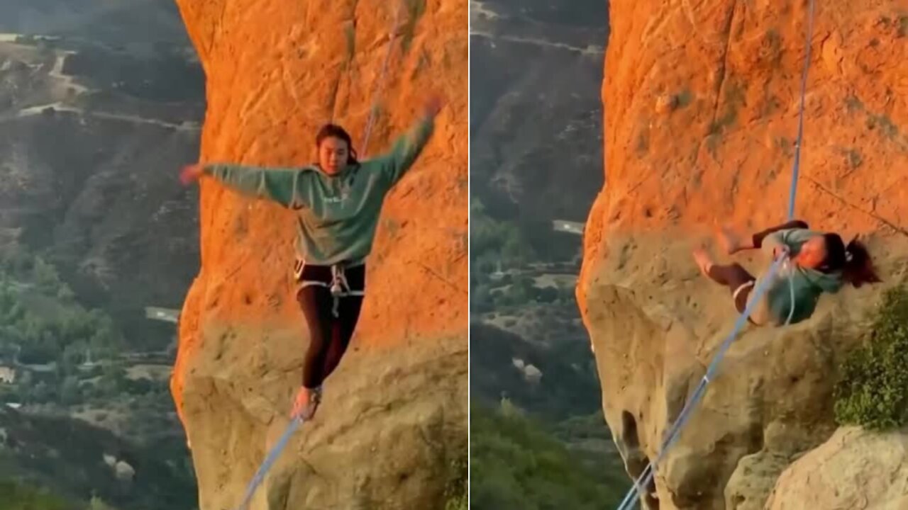 Girl doing rope walk between the mountains