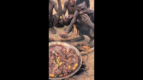 African tribal people eating meat