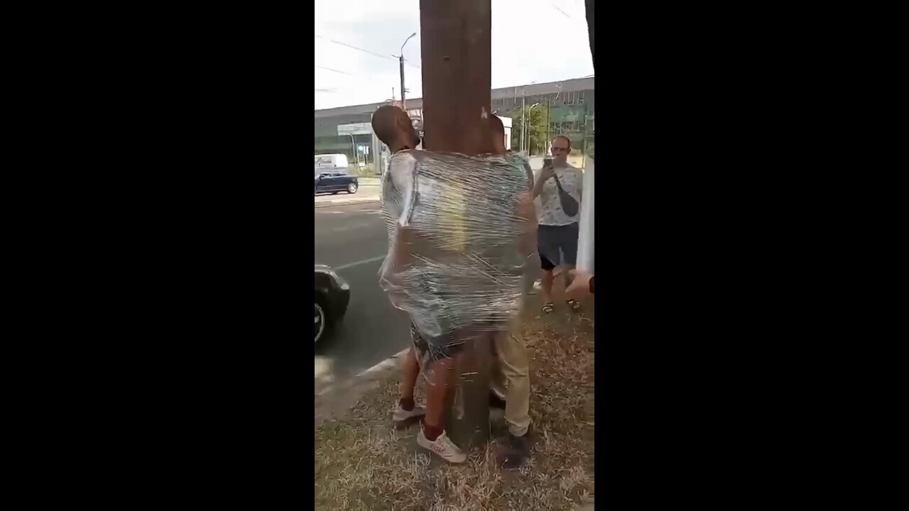 Two people are bound to a pole for public humiliation in Dnipro, Ukraine