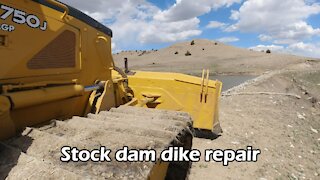 Dozer repairs flooded dam