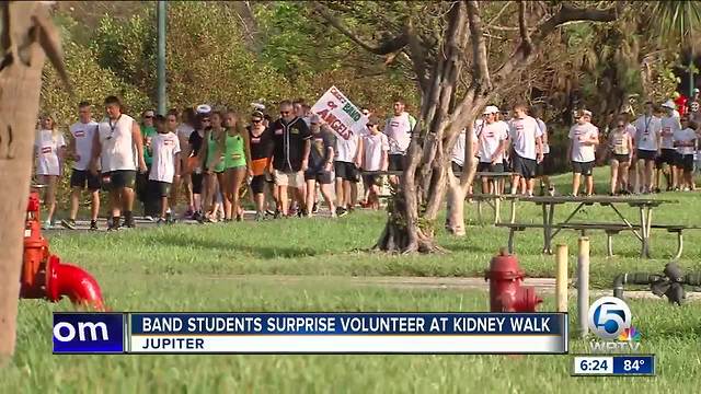 Band students surprise volunteer at kidney walk