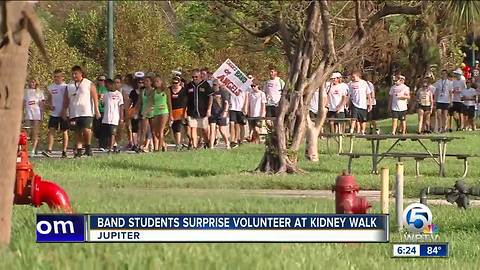 Band students surprise volunteer at kidney walk