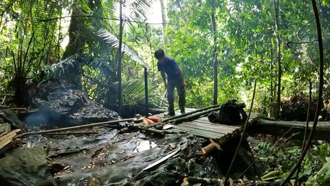 Building a bamboo shelter on a rock face:12