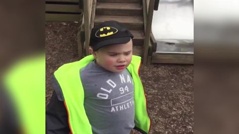 Boy Searches For His Batman Hat That Is On His Head