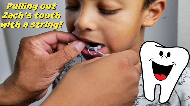 Pulling out loose tooth with a string!!!