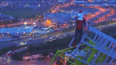 Man climbs 150-meter-high crane to deliver inspiring message