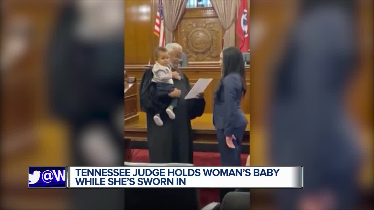 Judge hold woman's baby while swearing her in as lawyer