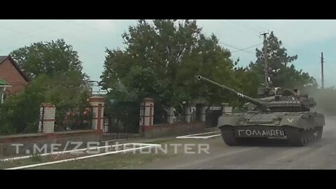 Russian tanks travel on the roads in a village near the front