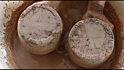 Earthy Soil Cakes Crumbling in Tub