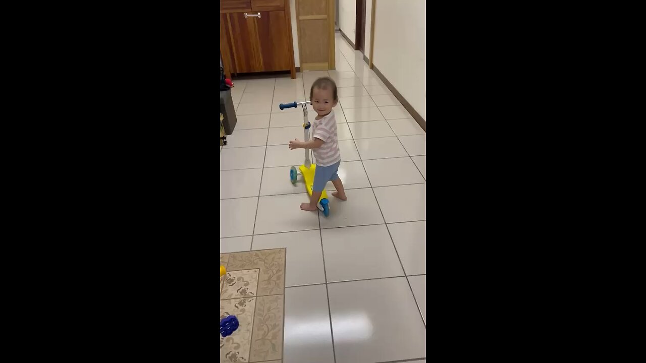 Adorable Baby's First Ride: Pedal Scooter Fun! 🛴