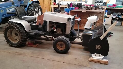 White Gt-1855 Yardboss garden tractor blowing snow.
