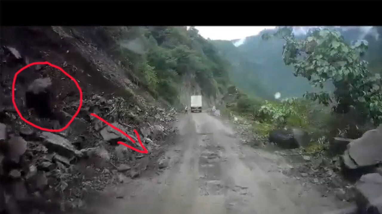 Driving through the construction of the mountain road, knocked down the fallen boulders