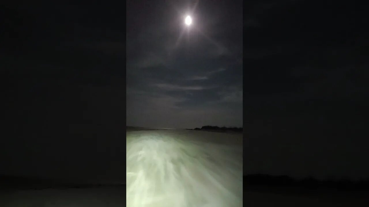 River of sand going over the edge at the beach under a BEAUTIFUL moonlit night.