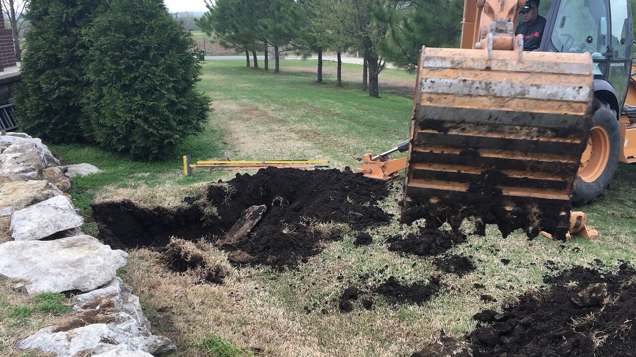 Backhoe digging the shelter