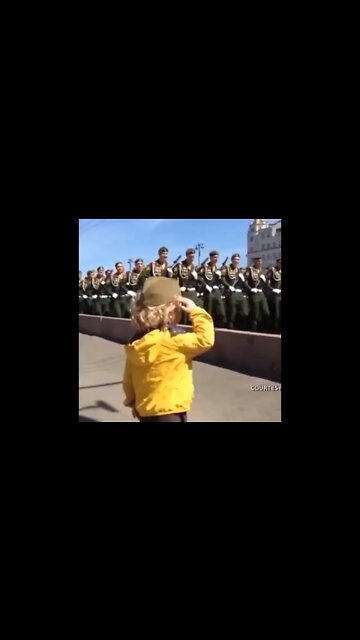 Kid salutes the troops during Victory Day rehearsal in Moscow in 2015