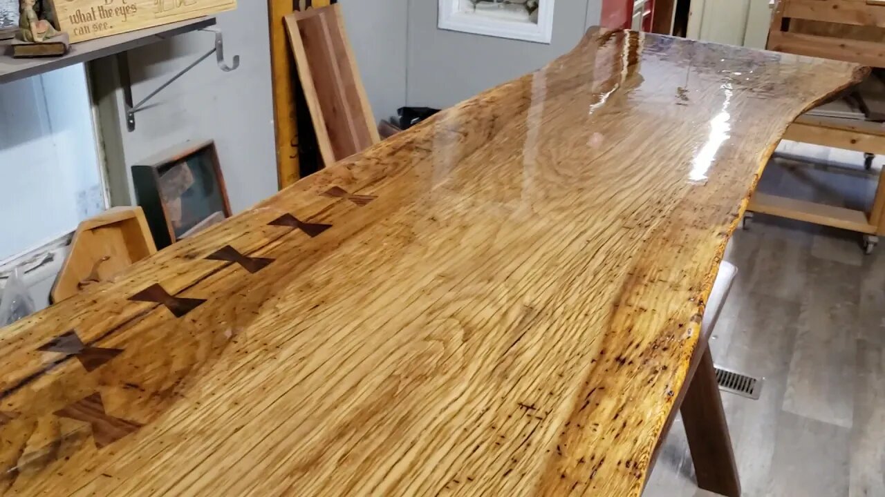 Live edge oak bar with walnut bowtie inlays and a walnut base.