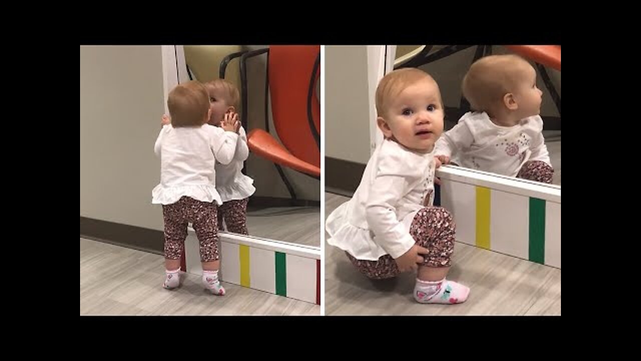 Baby girl loves who she sees in the mirror