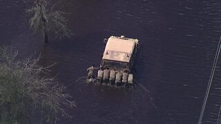 Military members move a Hummer near Venice