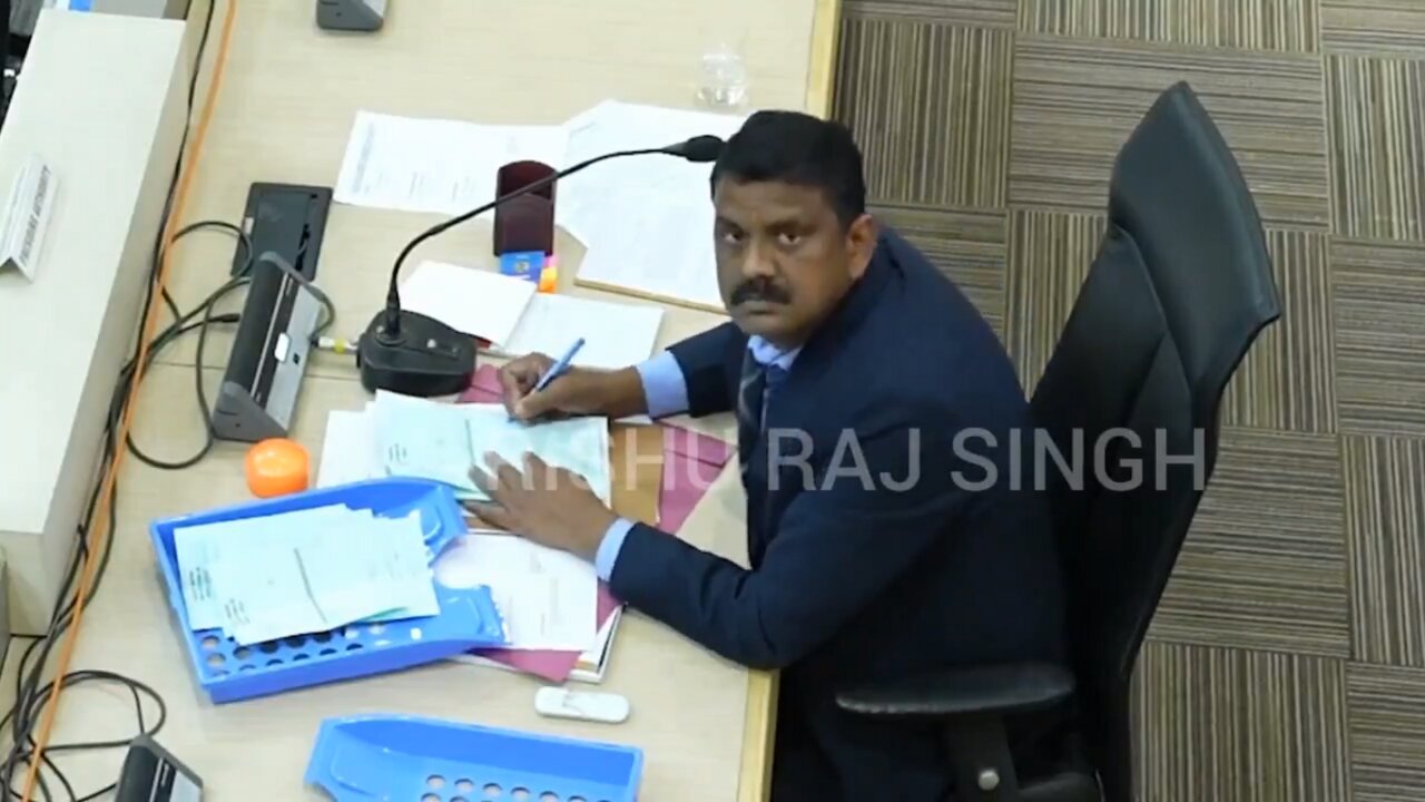 Election officer Tampering with Votes sees a CCTV Camera right above Him