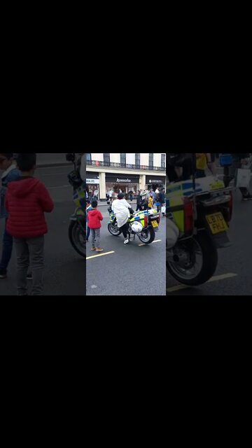 People queue up to sit on a police bike #metpolice