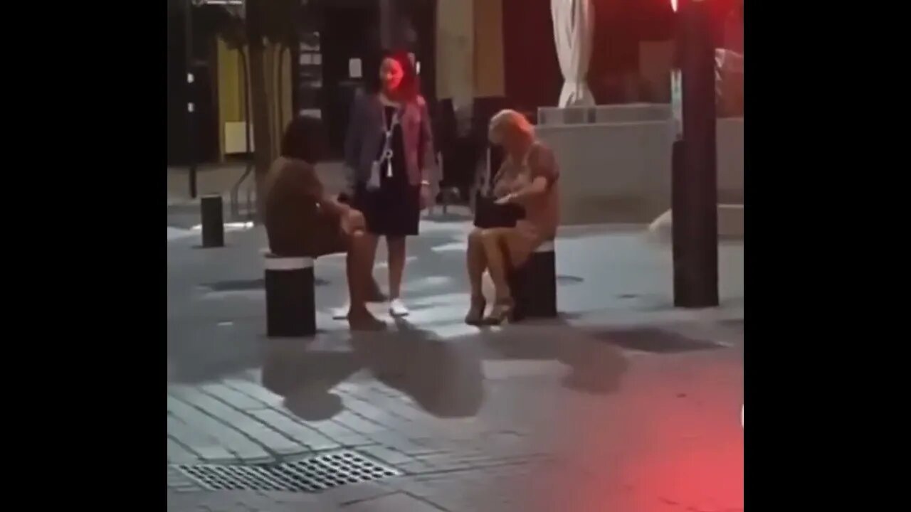 Women Sitting On Retracting Bollards Fall Flat On Their Behinds