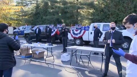 Obama and Biden meeting a few people in the parking lot in Flint, MI.