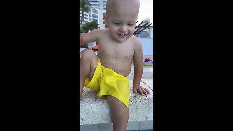 Funny baby reaction on the beach