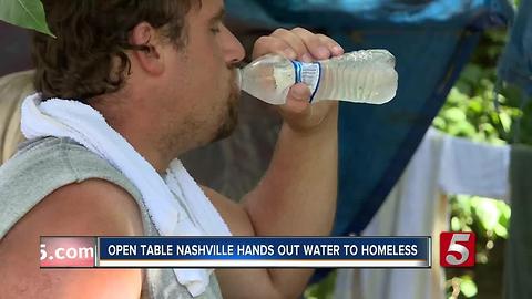 Outreach Workers Give Water To Homeless