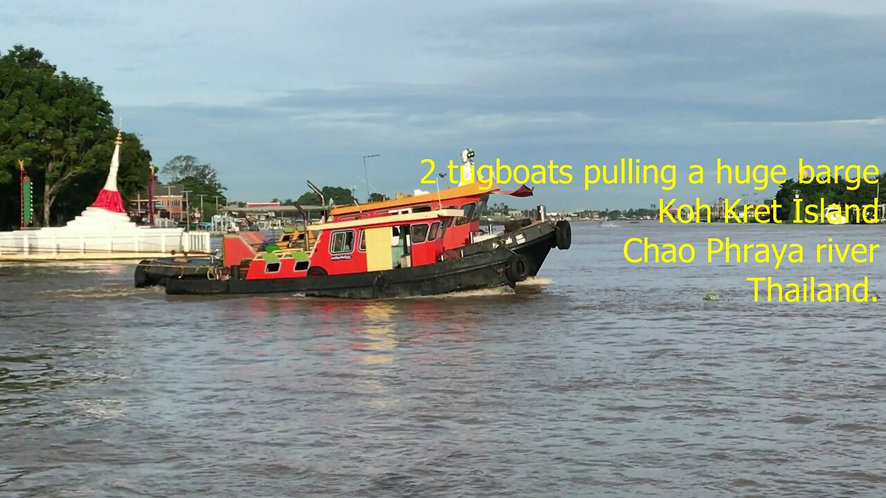 2 tugboats pulling a huge barge at Chao Phraya river Koh Kret island Thailand